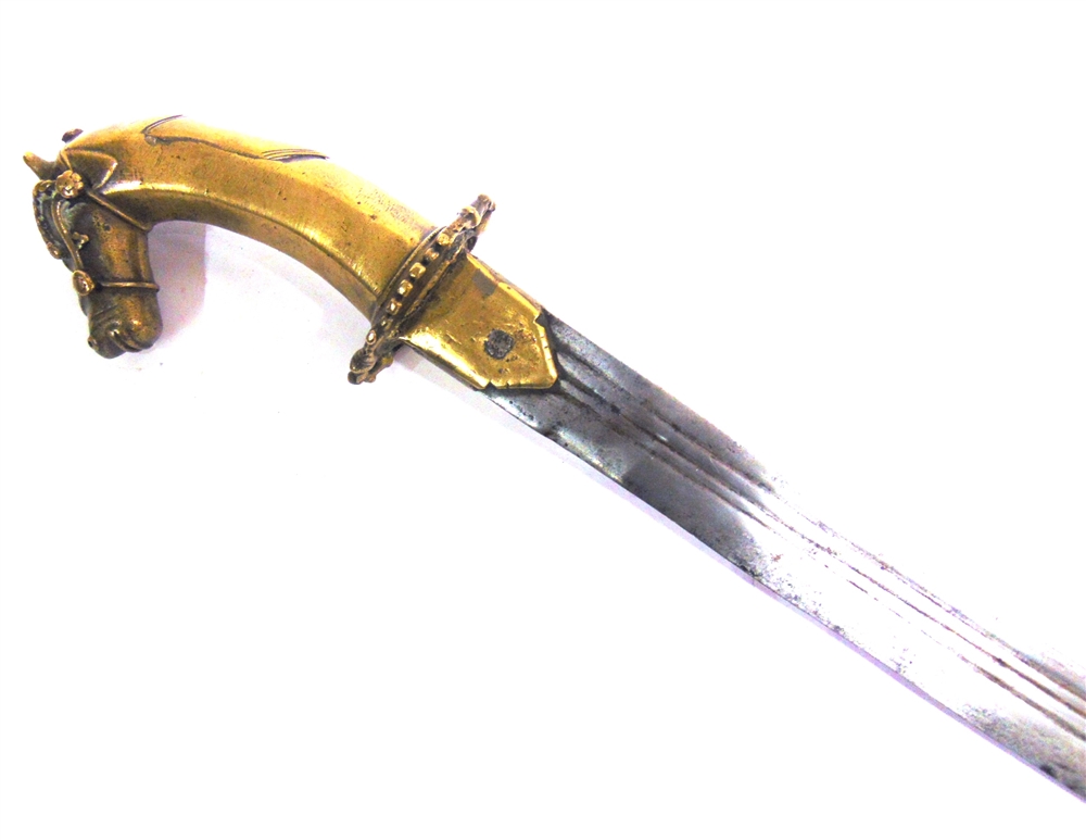 AN INDIAN TULWAR with a 73cm typically curved triple-fullered steel blade, and a brass hilt with a