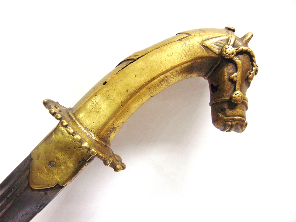 AN INDIAN TULWAR with a 73cm typically curved triple-fullered steel blade, and a brass hilt with a - Image 4 of 4