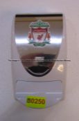 Hand sanitiser dispenser with LFC crest from the Medical Corridor at Liverpool Football Club's