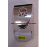 Hand sanitiser dispenser with LFC crest from the first floor landing at Liverpool Football Club's