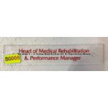 Clear acrylic HEAD OF MEDICAL REHABILITATION & PERFORMANCE MANAGER door sign from  the Captains'