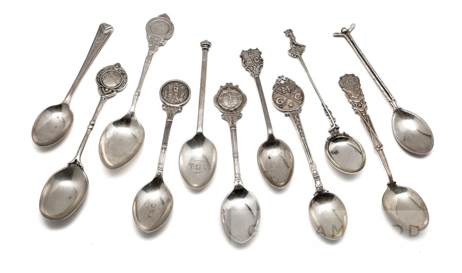 Eleven hallmarked English silver prize golf spoons, the finials with golfing scenes, golf figures,