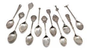 Eleven hallmarked English silver prize golf spoons, the finials with golfing scenes, golf figures,