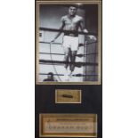 Original section of Muhammad Ali’s jumping rope and b & w photograph of Ali using it, photograph