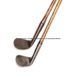 Two 19th century smooth face rut irons, each with heavy iron head, hickory shaft, one with