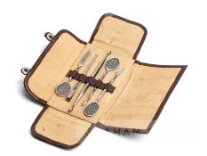 Leather pouched manicure set, circa 1920s, comprising three silver-handled file and cuticle