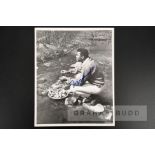 Muhammad Ali signed photograph, 8 by 10in. portraying the boxing champion during downtime eating