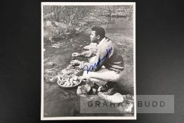 Muhammad Ali signed photograph, 8 by 10in. portraying the boxing champion during downtime eating