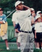 Tiger Woods signed colour photograph, depicting Woods swinging a club, signed in black marker pen,