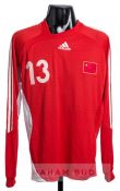 A red China No.13 home jersey, unknown player, circa 2006,  long sleeved with country emblem badge