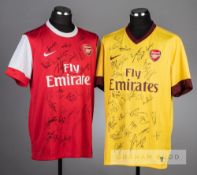 Two Arsenal replica jerseys signed by the squad and management, comprising a red Arsenal replica