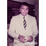 Signed colour photograph of boxing legend Muhammad Ali, circa 1980s, depicting Ali in a suit and tie