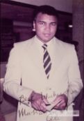 Signed colour photograph of boxing legend Muhammad Ali, circa 1980s, depicting Ali in a suit and tie