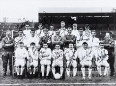 Leeds United b&w team signed photograph, circa 1964-65, depicted seated and standing in front of a