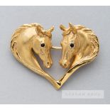 A Harriet Glen 9ct gold and blue sapphire horsehead heart brooch, modelled as two horse heads with