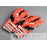 Arsenal's Emiliano Martinez Puma Evopower goalkeeper's gloves, the orange, black and white gloves