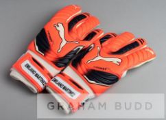Arsenal's Emiliano Martinez Puma Evopower goalkeeper's gloves, the orange, black and white gloves