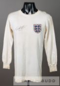 A white England No.9 jersey circa 1964 signed by Geoff Hurst, by Bukta, long-sleeved embroidered