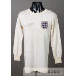 A white England No.9 jersey circa 1964 signed by Geoff Hurst, by Bukta, long-sleeved embroidered