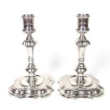 A George II pair of solid silver candlesticks, mid 18th century