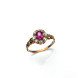 Yellow gold synthetic ruby and diamond cluster ring.