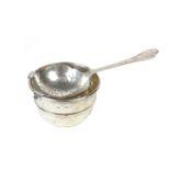 A silver tea strainer on a stand, 20th century