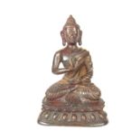 A Tibetan gilt bronze Buddha, 19th century or earlier