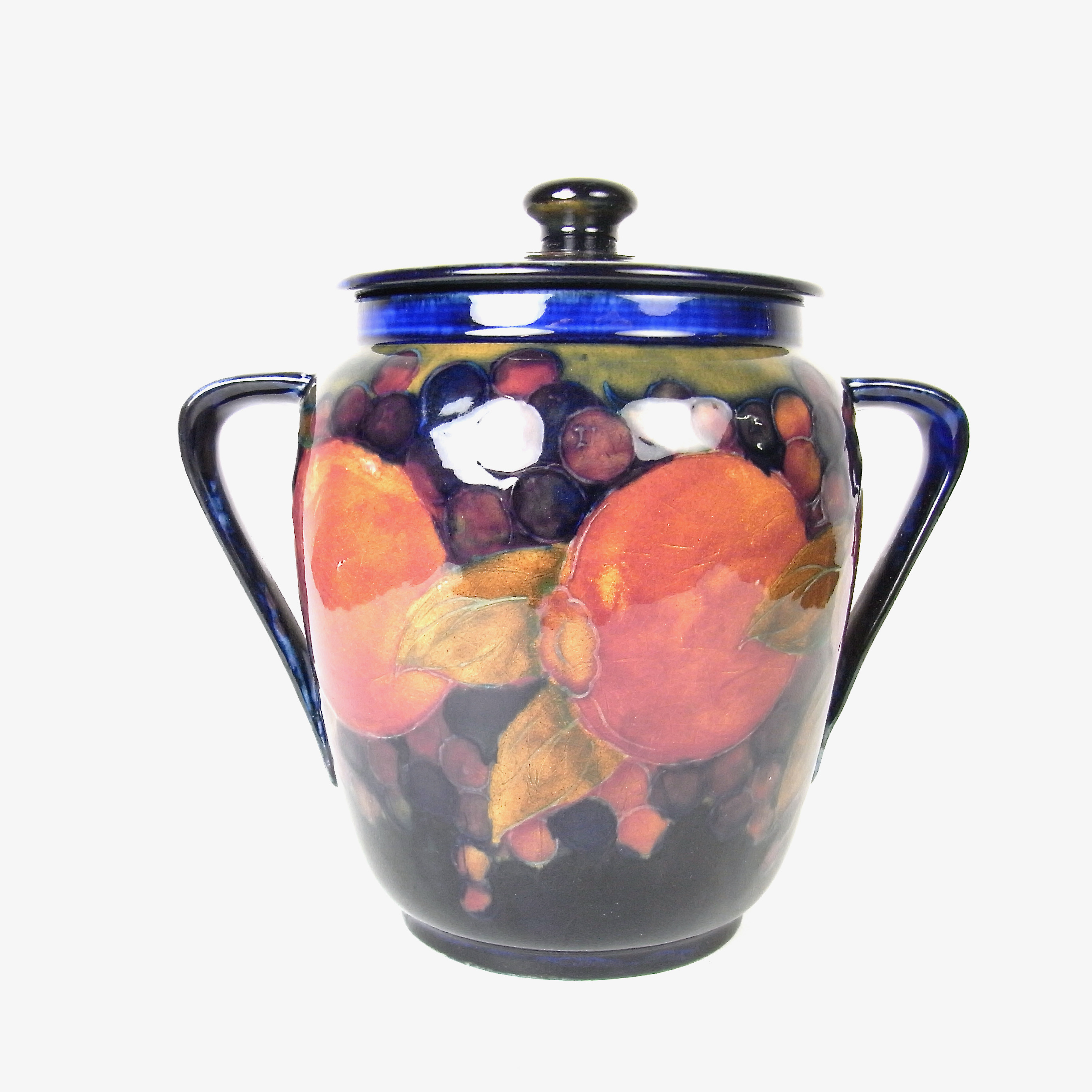 A William Moorcroft Pomegranate pattern twin handled vase and cover, Burslem, circa 1916