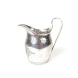 A George III engraved cream jug.