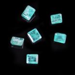 Six loose emerald cut emeralds weighing a total of 6.40 ct.