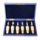 A set of six Victorian gilt silver figural wine corks