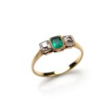Yellow gold emerald and diamond three stone ring.