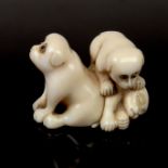 A Japanese carved ivory netsuke of puppies, Meiji/Taisho period