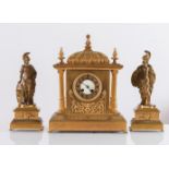Trittico in bronzo dorato composto da orologio e due sculture, Francia, XIX secolo.