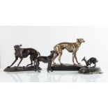 Lotto composto da quattro sculture raffiguranti “Cani” di diverse fogge e materiali, XX secolo.