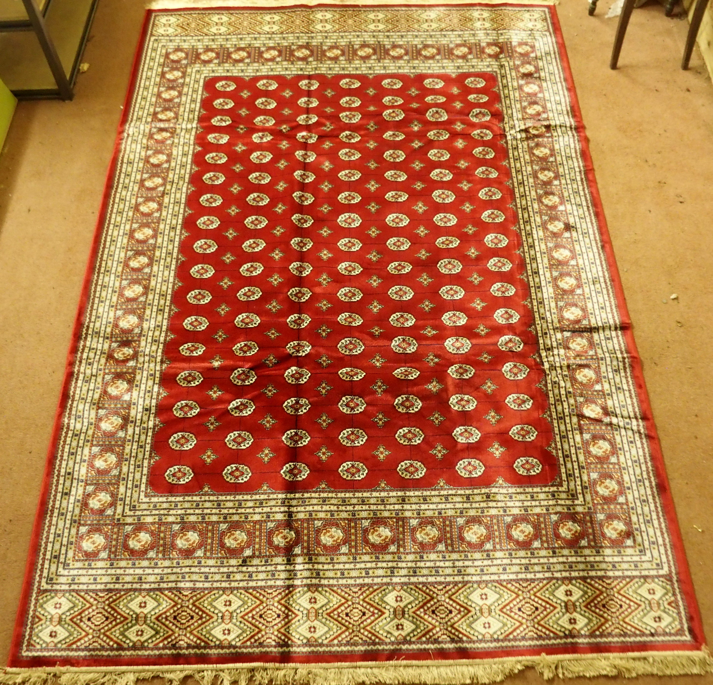 A Kashmir rug with a red ground Bokhara design, 300cm x 197cm Condition Report: Available upon