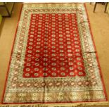 A Kashmir rug with a red ground Bokhara design, 300cm x 197cm Condition Report: Available upon