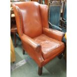 A leather wingback armchair (af) Condition Report: Available upon request