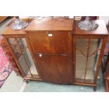 A walnut cabinet with drop flap, lower door flanked by two glazed doors, 108cm high x 118cm wide x