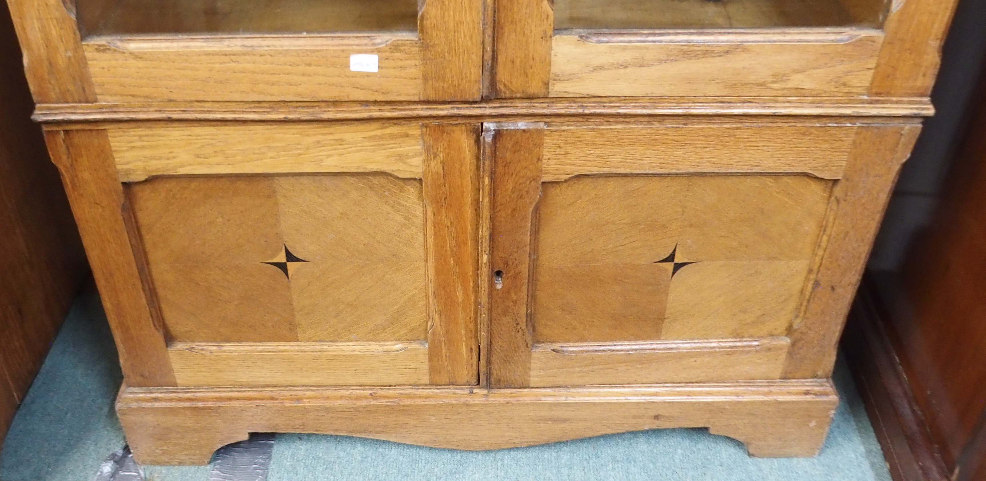 An oak bookcase with two glazed doors over doors with central inlay, 191cm high x 95cm wide x 34cm - Image 3 of 3