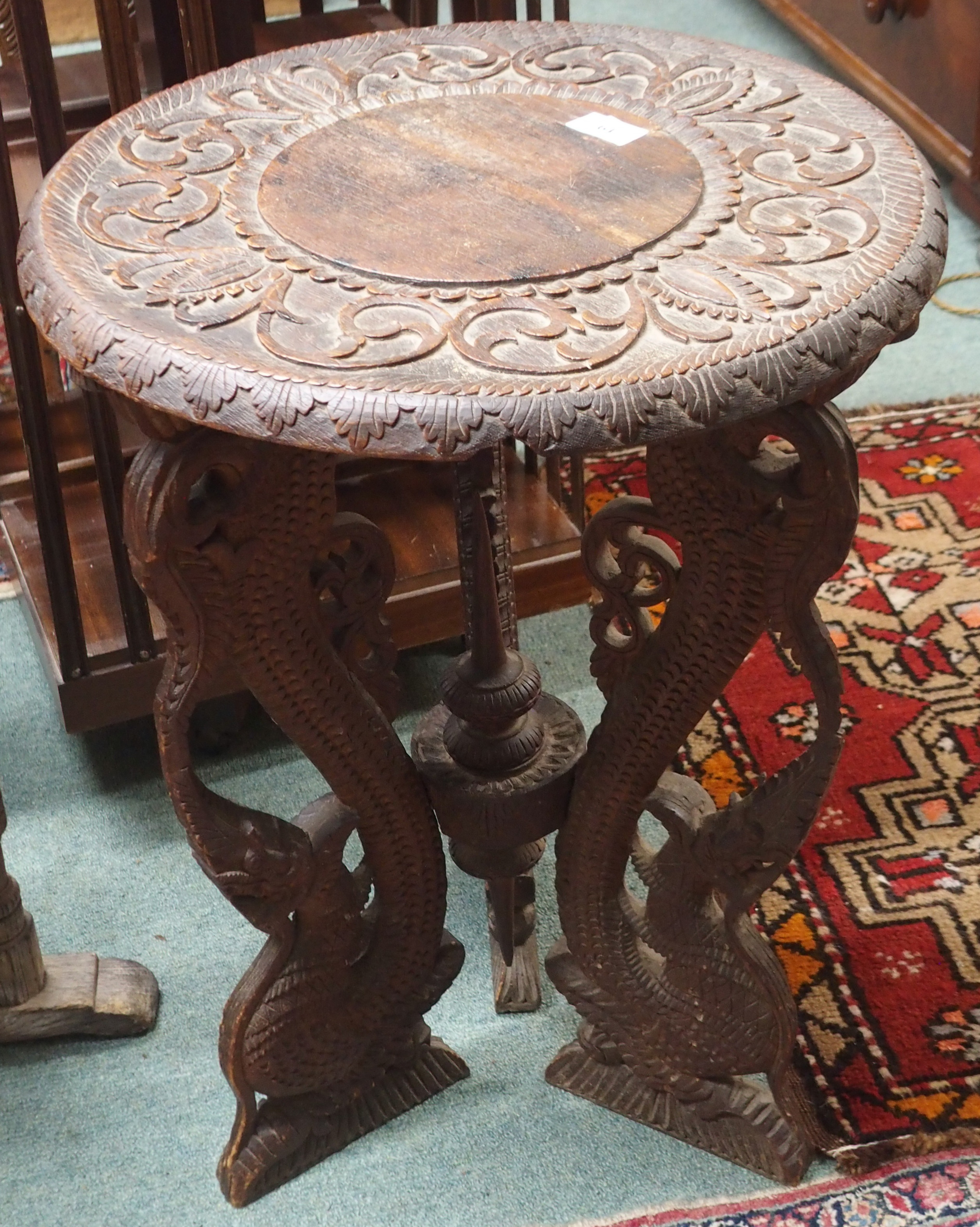 A carved hardwood oriental occasional table, 60cm high x 46cm diameter Condition Report: Available