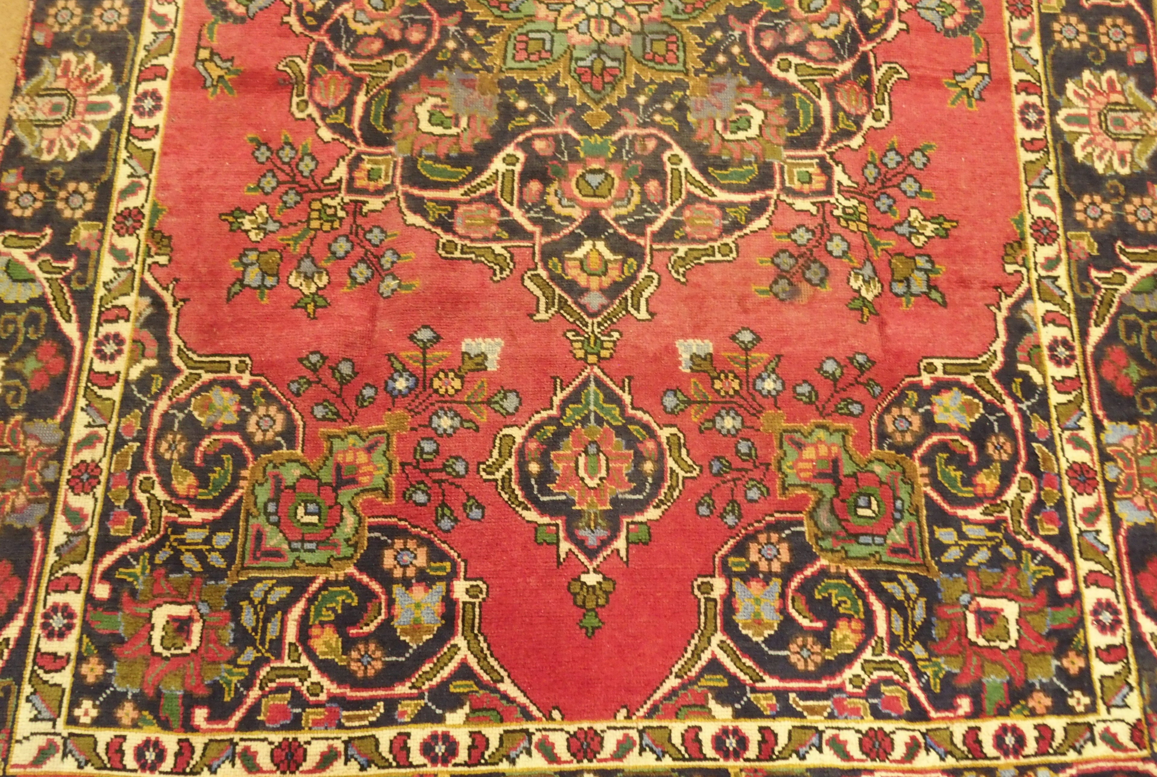 A red ground vintage Tabriz rug with floral medallion design, 282cm x 186cm Condition Report: - Image 3 of 5
