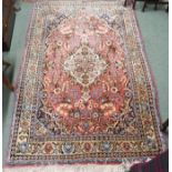 A pink ground Sarough rug with a cream central medallion and floral design, 158cm x 104cm