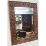 A carved oak wall mirror, 82cm x 59cm Condition Report: Available upon request