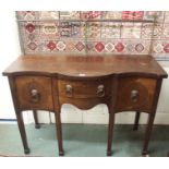 A serpentine front mahogany sideboard with brass rail and lion head handles, 126cm high x 124cm wide