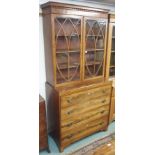 A 19th Century inlaid mahogany glazed bookcase on a base with four graduated drawers on bracket feet