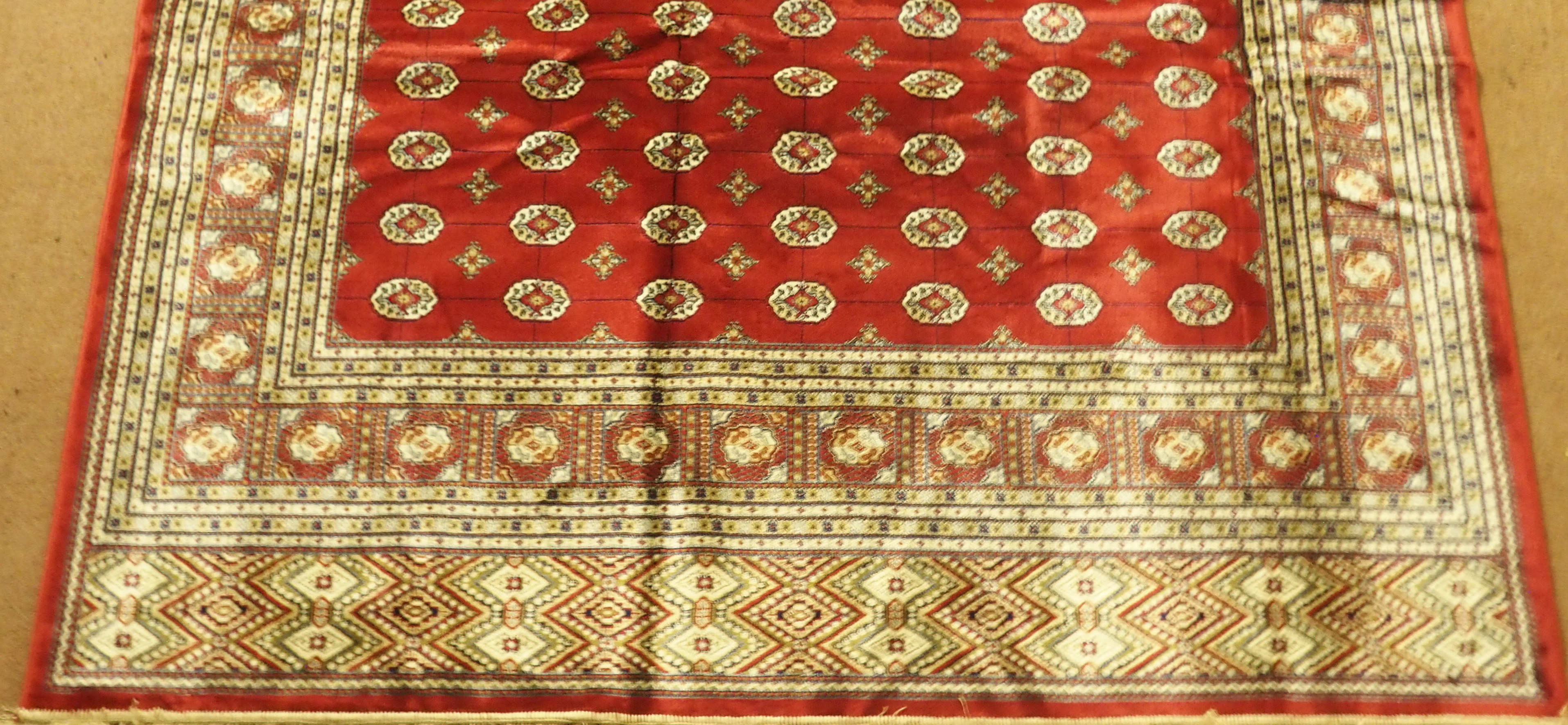 A Kashmir rug with a red ground Bokhara design, 300cm x 197cm Condition Report: Available upon - Image 2 of 3