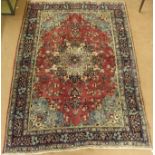 A deep pink ground Tabriz rug with central medallion and a main blue border, 275cm x 200cm Condition