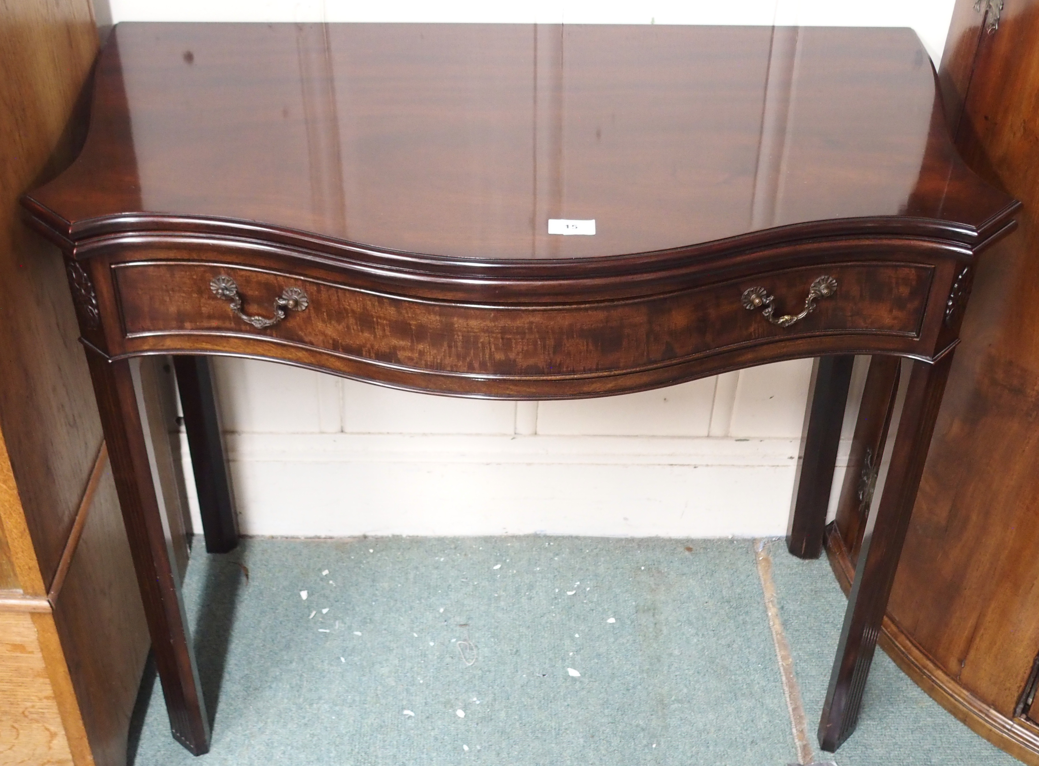 A reproduction mahogany serpentine front tea table with single drawer, 73cm high x 87cm wide