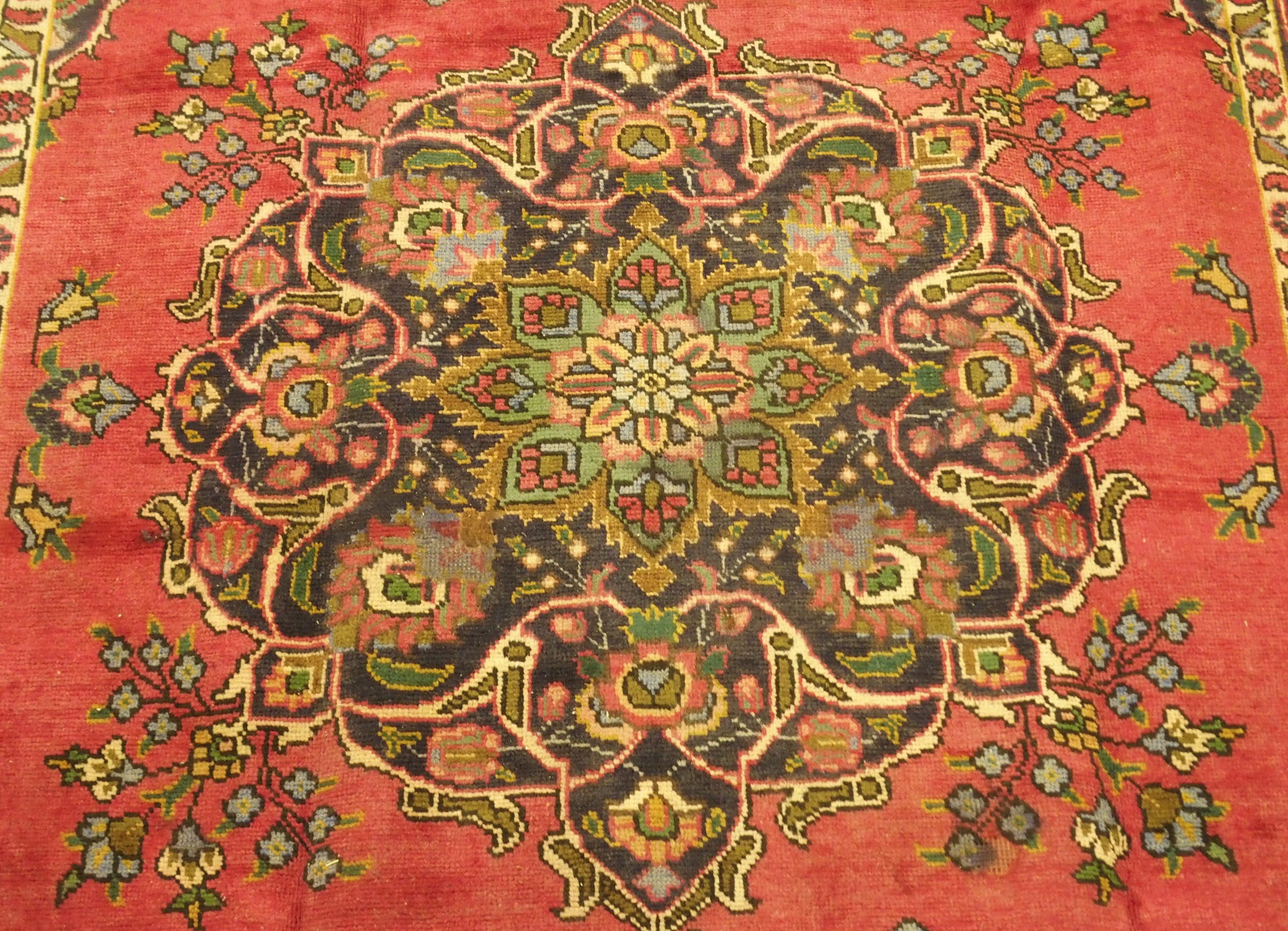 A red ground vintage Tabriz rug with floral medallion design, 282cm x 186cm Condition Report: - Image 2 of 5